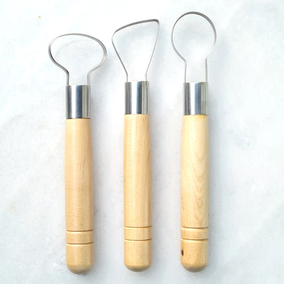 Three wax scrapers, 5mm wide looped in a circular, oval and triangl shaped heads. Wooden handles.